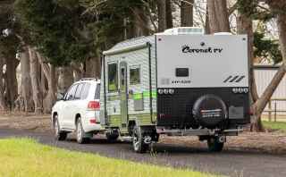 Car towing caravan on the road