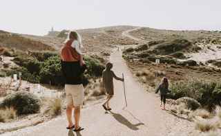 Family walking on the beach track