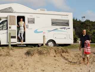 Couple at the beach with a caravan 